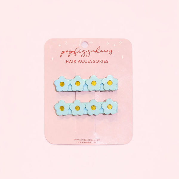 611fc05e3c4ce80992caae23_blue-flower-hair-clips-on-pink-background-copy_1771223563642.jpg