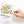 Load image into Gallery viewer, A hand holds the Onderkast Studio Thinking of You Flowers Greeting Card, featuring a striped vase with yellow and white flowers. The card says Thinking of you in script—an elegant floral design for any occasion.
